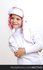 Portrait of little kid in winter wear against white background