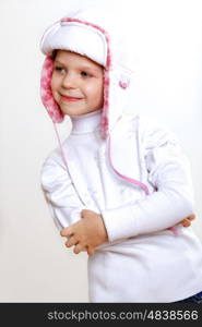 Portrait of little kid in winter wear against white background