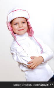 Portrait of little kid in winter wear against white background