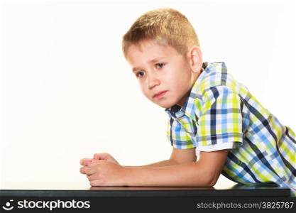 Portrait of little serious blonde boy child studio shot isolated on white
