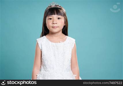 Portrait of little young cute asian girl wear like a princess . isolated on light green background .