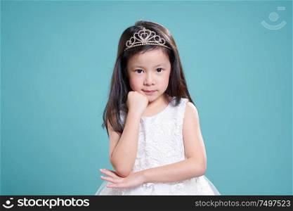 Portrait of little young cute asian girl wear like a princess . isolated on light green background .