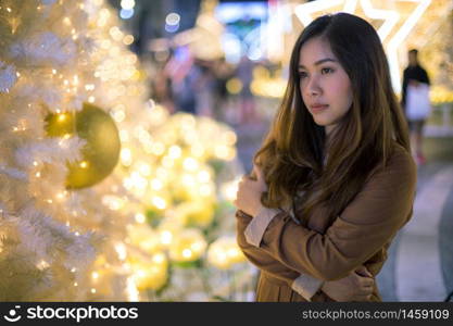 Portrait of lonely asian woman, outdoor in night. Christmas and New Year concept