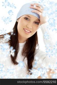 portrait of lovely brunette in winter hat with snowflakes
