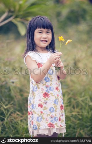 portrait of lovely girl with yellow cosmos flower bouquet in hand toothy smiling face