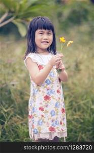 portrait of lovely girl with yellow cosmos flower bouquet in hand toothy smiling face