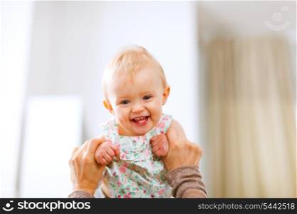 Portrait of lovely laughing baby playing with mother&#xA;
