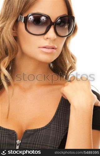 portrait of lovely woman in shades over white