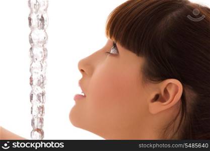 portrait of lovely woman with icicle over white