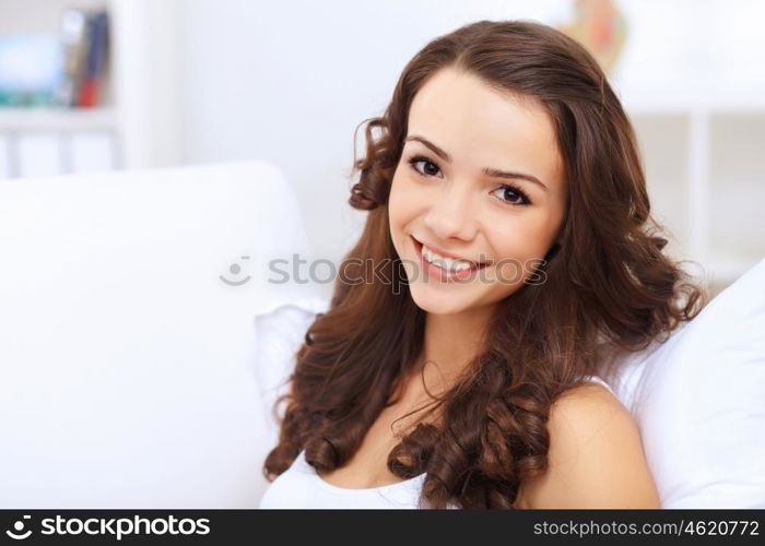 Portrait of lovely young woman having cup of tea at home