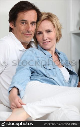 Portrait of loving couple sitting indoors