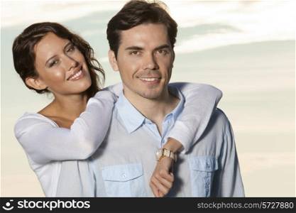 Portrait of loving couple smiling together at beach