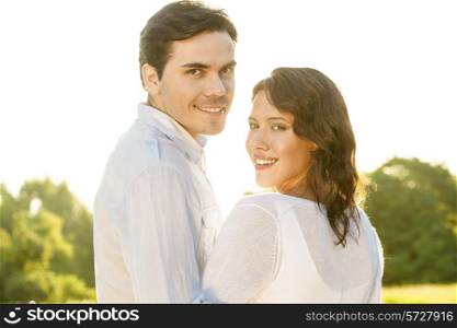 Portrait of loving couple smiling together in park