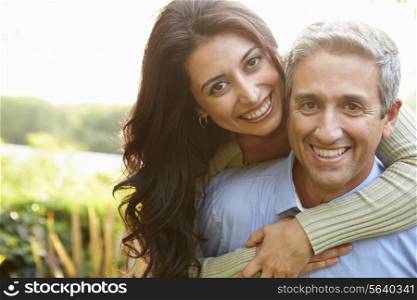 Portrait Of Loving Hispanic Couple In Countryside