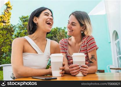 Portrait of loving lesbian couple spending good time together and having a date at coffee shop. LGBT., love and relationship concept.