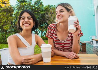 Portrait of loving lesbian couple spending good time together and having a date at coffee shop. LGBT., love and relationship concept.