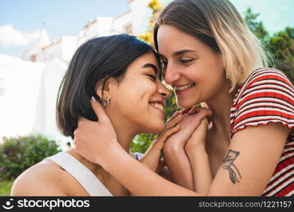 Portrait of loving lesbian couple spending time together and having a date outdoors. LGBT., love and relationship concept.