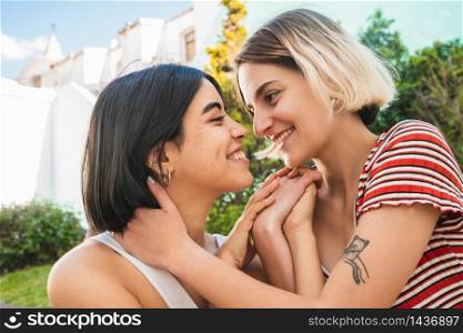 Portrait of loving lesbian couple spending time together and having a date outdoors. LGBT., love and relationship concept.