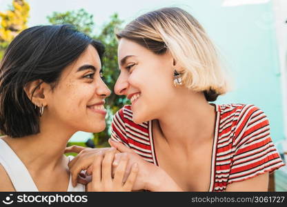 Portrait of loving lesbian couple spending time together and having a date outdoors. LGBT., love and relationship concept.