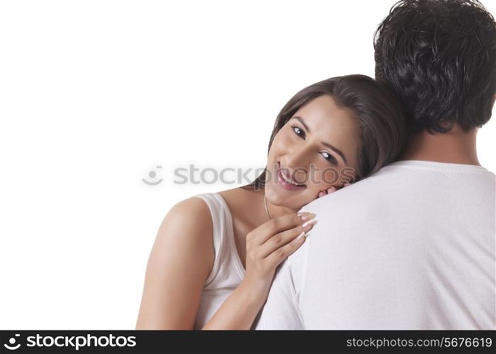 Portrait of loving woman resting head on man&rsquo;s shoulder against white background