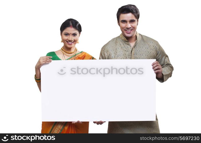 Portrait of Maharashtrian couple holding a placard