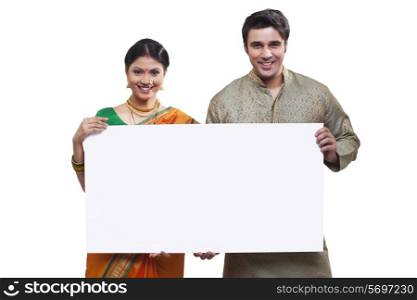 Portrait of Maharashtrian couple holding a placard