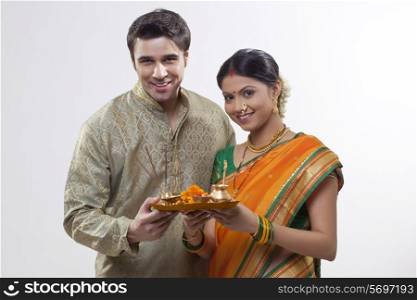 Portrait of Maharashtrian couple holding a puja thali