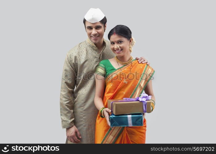 Portrait of Maharashtrian couple holding gifts