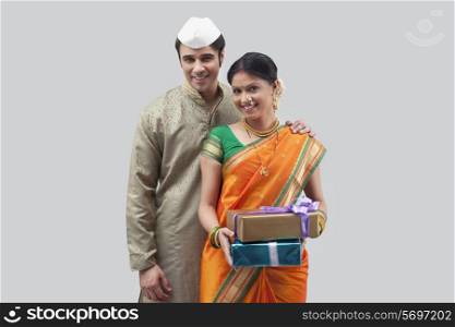 Portrait of Maharashtrian couple holding gifts
