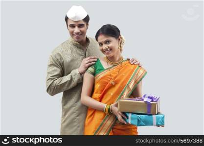Portrait of Maharashtrian couple holding gifts