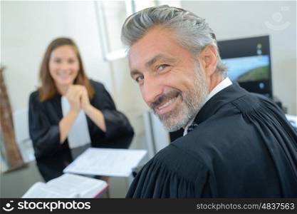 Portrait of male and female lawyers in robes
