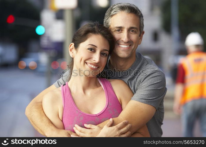 Portrait Of Male And Female Runners On Urban Street