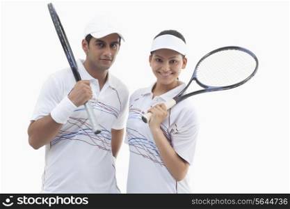Portrait of male and female tennis players holding rackets isolated over white background