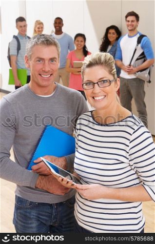 Portrait Of Male And Female Tutors In Class With Students