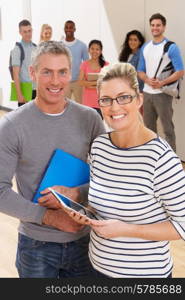 Portrait Of Male And Female Tutors In Class With Students