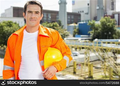 Portrait of male architect wearing reflective workwear at construction site