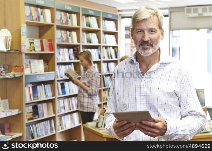 Portrait Of Male Booshop Owner Using Digital Tablet