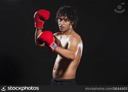 Portrait of male boxer over white background