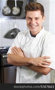 Portrait Of Male Chef Standing In Kitchen
