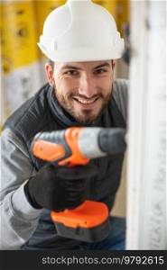 portrait of male construction worker usinga cordless drill
