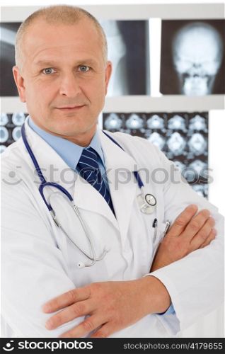 Portrait of male doctor standing at front of set x-ray