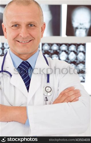 Portrait of male doctor standing at front of set x-ray