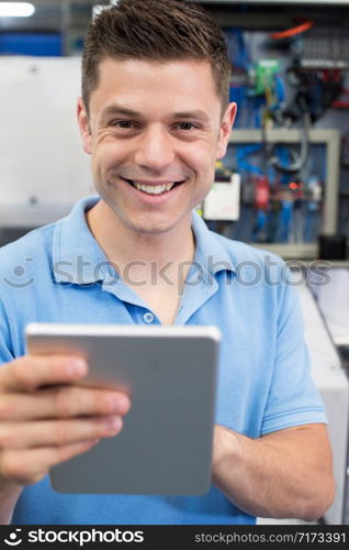 Portrait Of Male Engineer In Factory With Digital Tablet