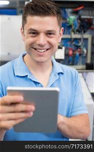 Portrait Of Male Engineer In Factory With Digital Tablet
