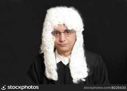 Portrait Of Male Judge in a wig on black background