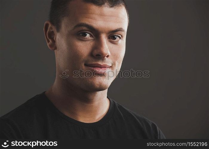 Portrait of male latino model over a gray background