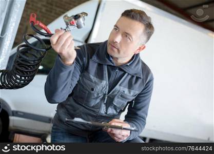 portrait of male mechanic at work in the garage