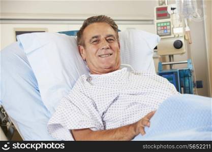Portrait Of Male Patient Relaxing In Hospital Bed