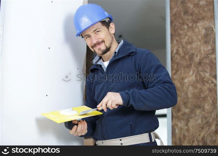 portrait of male plasterer on site