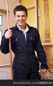 Portrait Of Male Plumber Working In House